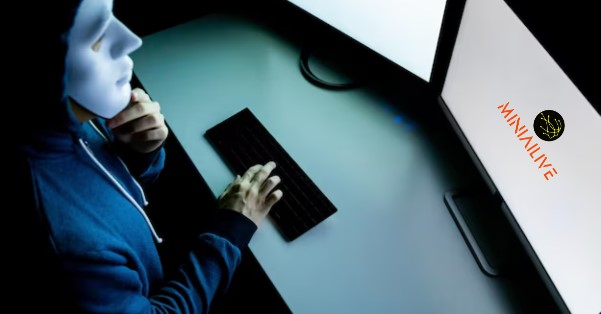 man with mask sitting in front of computer screen preventing online fraud